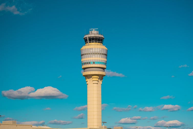 Air traffic control tower, blue sky with clouds