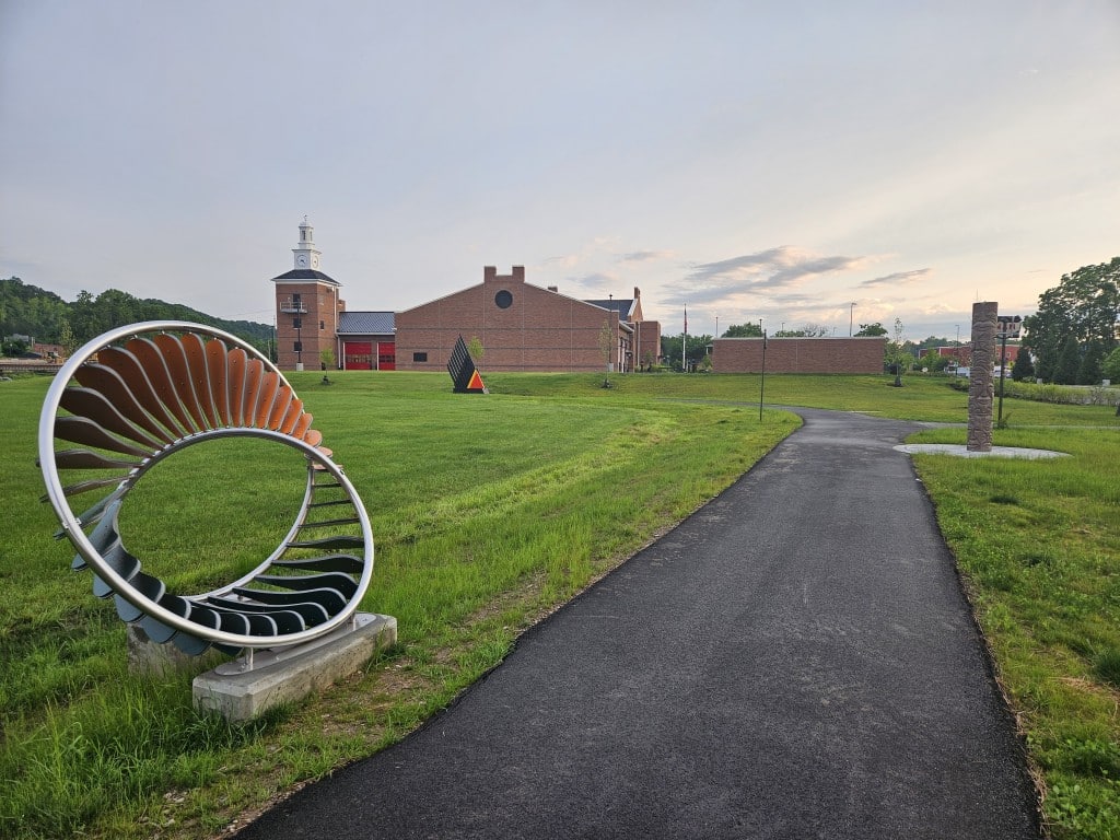 Art Walk with the new headquarters of the Stimson Fire Station in the background.