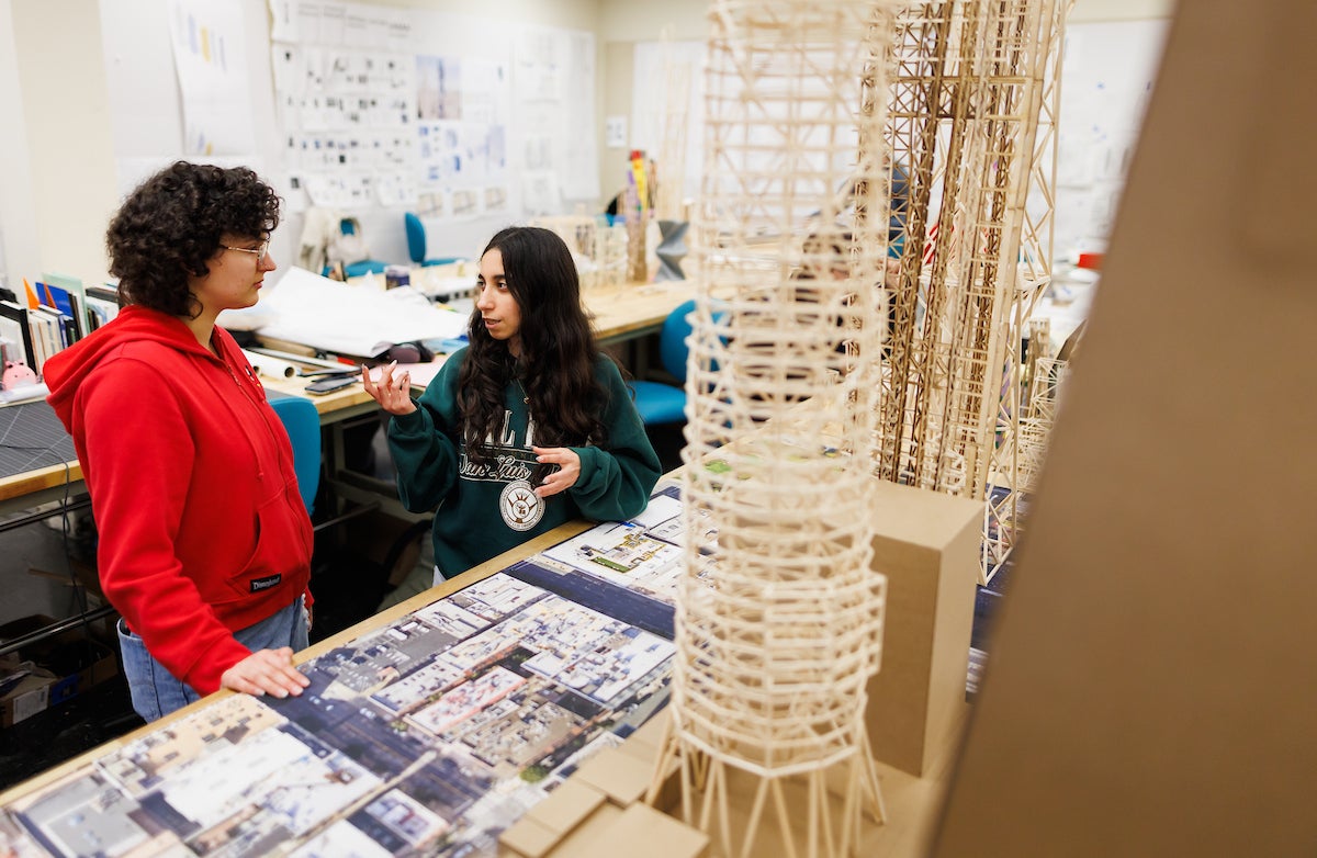 In addition to wooden scale models of skyscrapers, the students speak in the studio.
