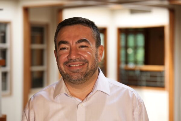 A portrait of a smiling man, Abdullah Antepli.