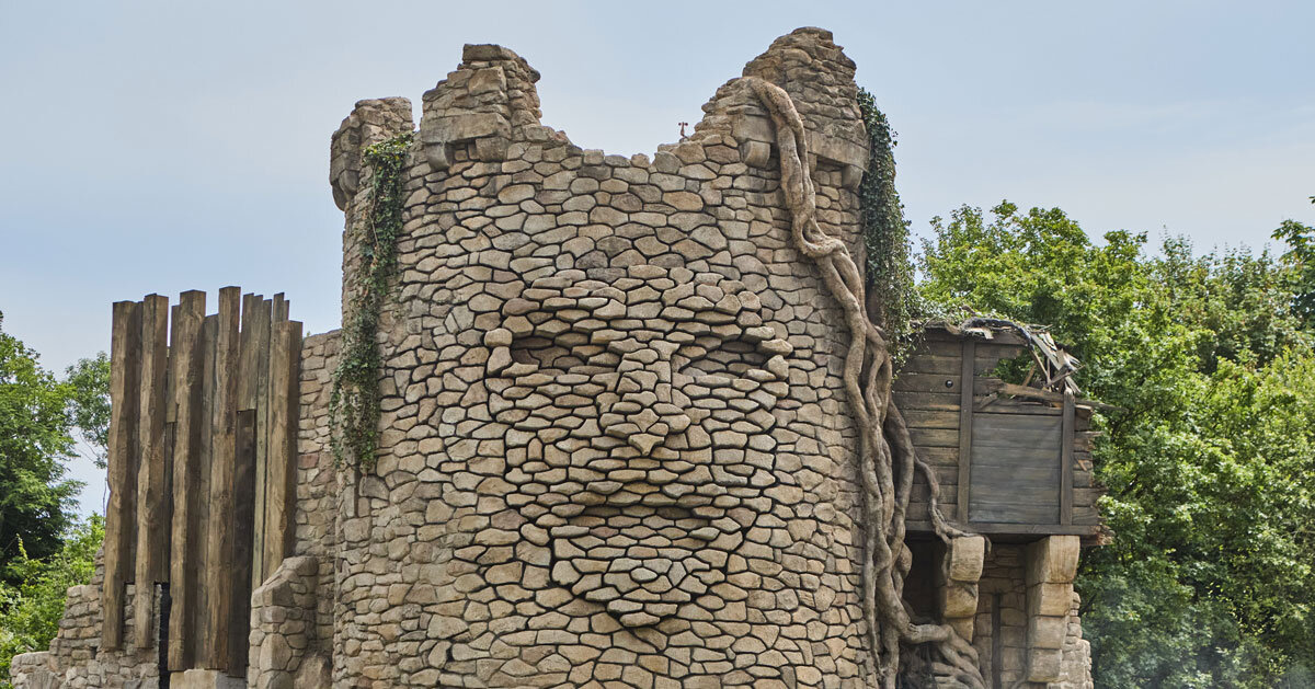 Kinetic sculptures outlined the face into the tower's masonry in the French theme park.