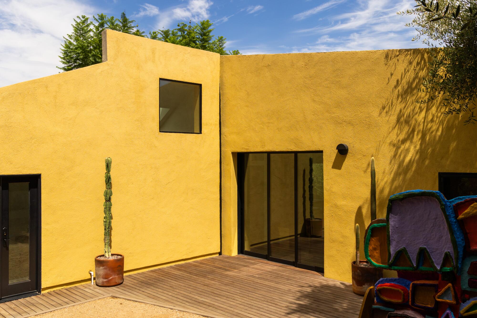The exterior facade of a yellow house.