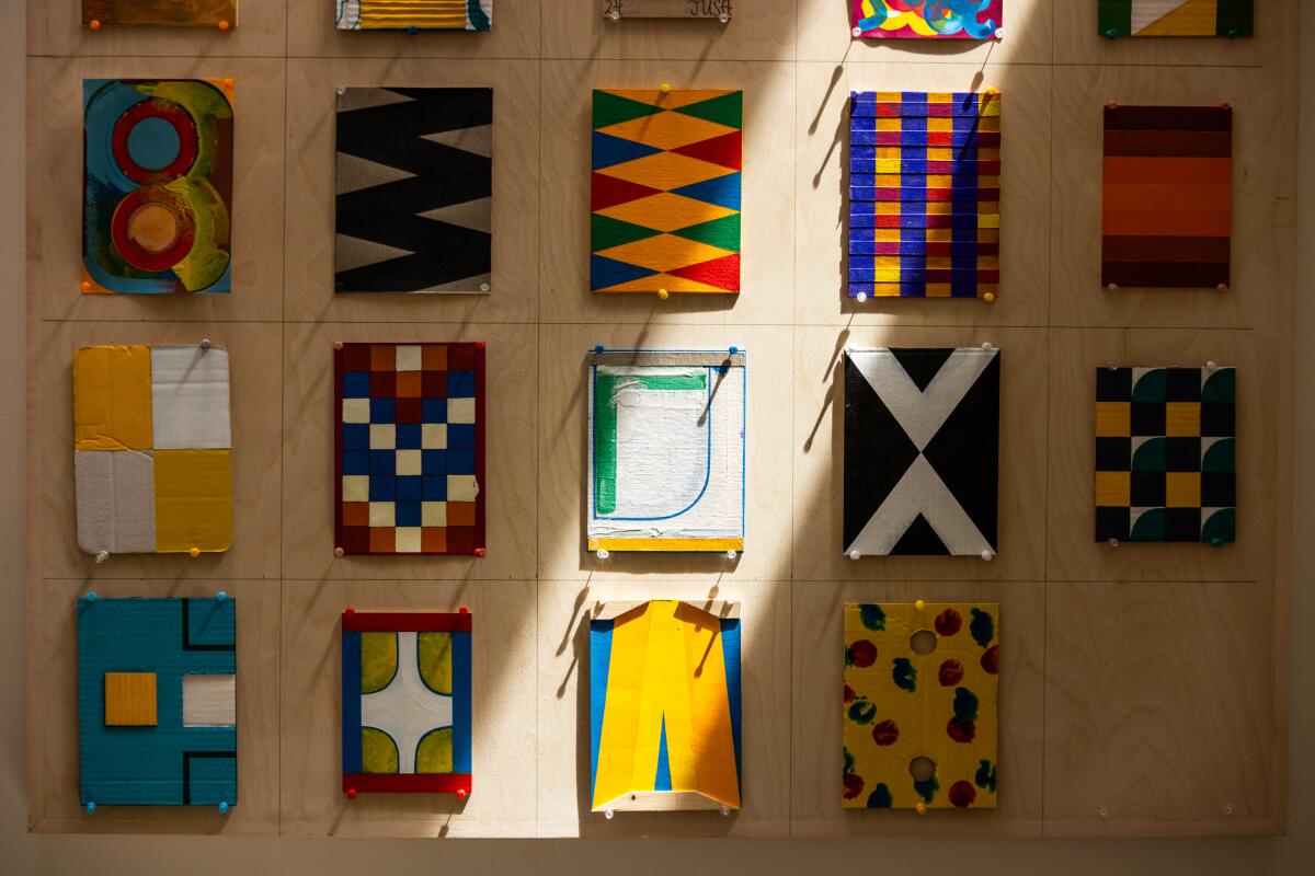 Los Angeles, CA – August 21: Geometric painted canvases hang in Antonio Adriano Puleo's ADU at his home in Glassell Park on Thursday, August 21, 2025 in Los Angeles, CA. (Juliana Yamada/Los Angeles Times)