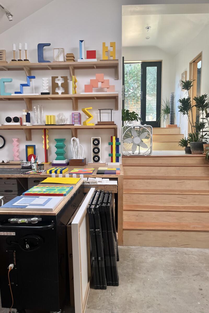 Stairs lead from an art studio up to an ADU.