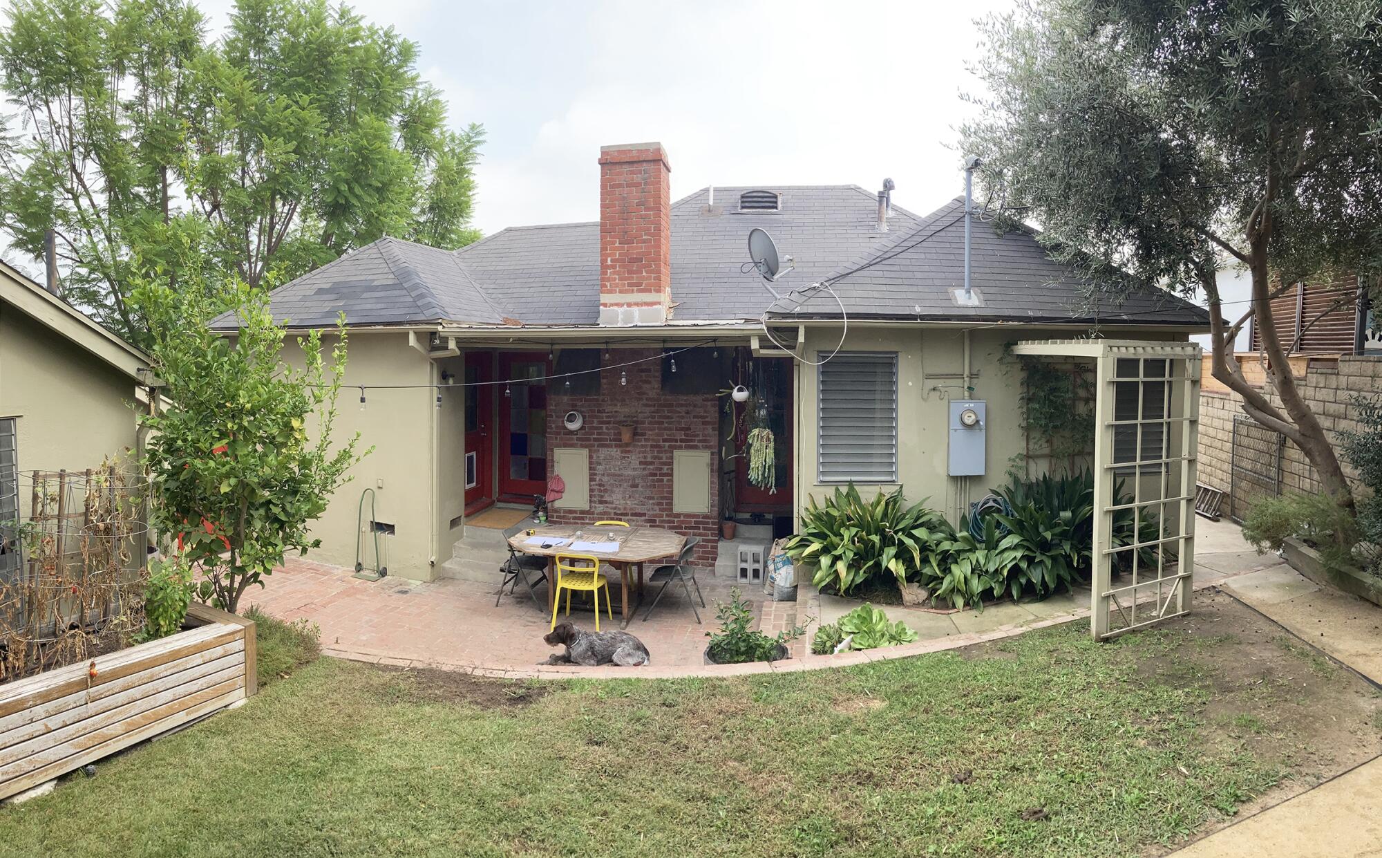 The back of a 1946 bungalow, patio and backyard.