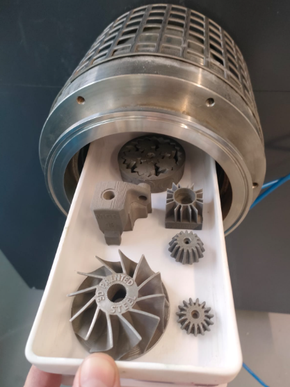 Metal parts fresh from the Zetasinter 4L oven. Photo via Nanoe.